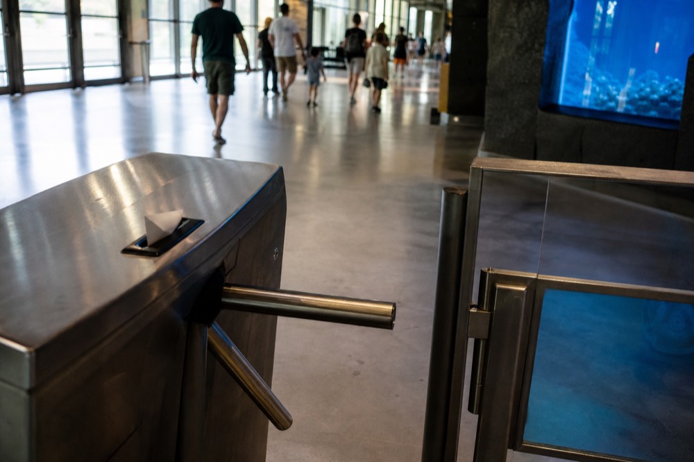Ticket turnstile at a Kuala Lumpur aquarium entrance, no text, no logos, no people
