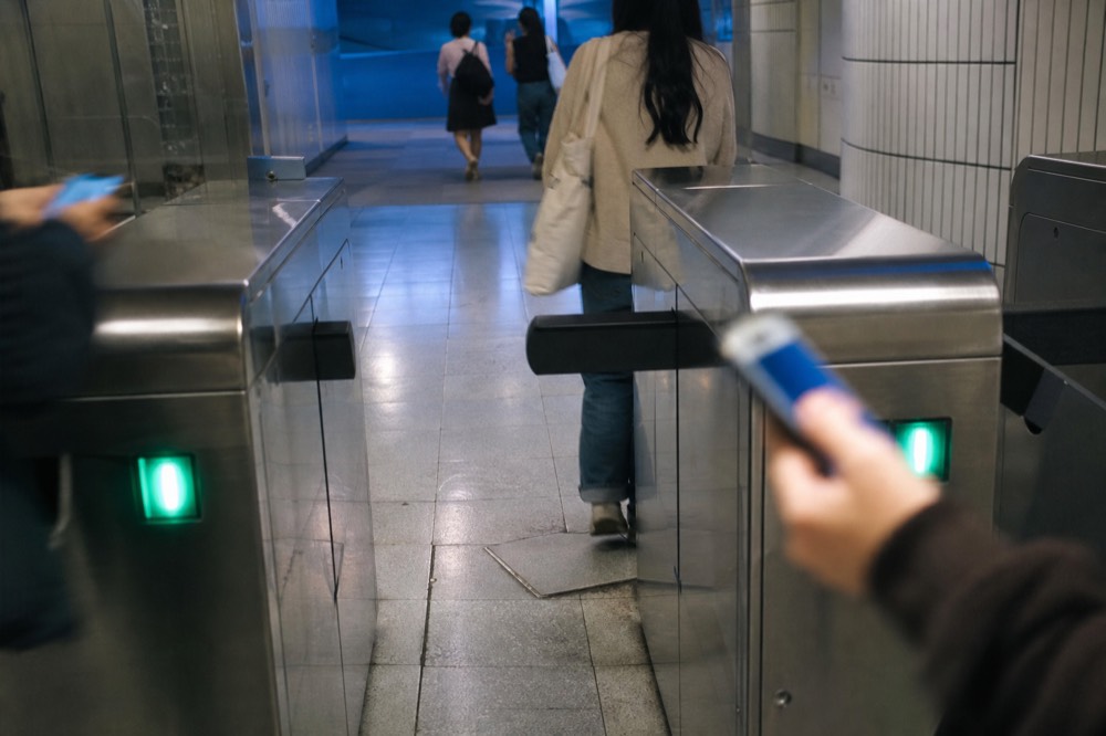Visitors scanning e-tickets at the Aquaria KLCC turnstile, no text, no logos, no people