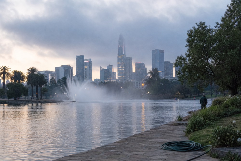 Petronas Twin Towers seen from the KLCC park lake in the early evening, no text, no logos, no people