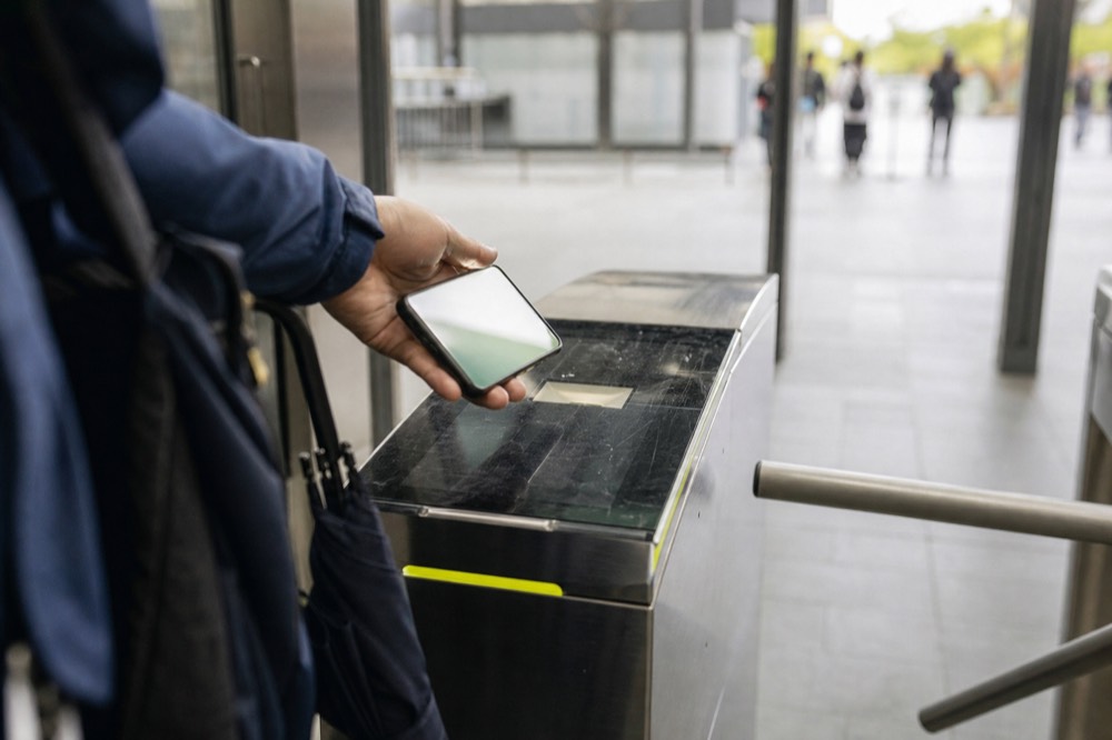 Smartphone showing an e-ticket at an aquarium entrance gate, no text, no logos, no people