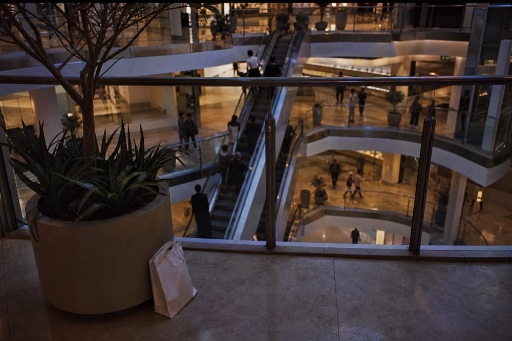 A bright modern mall atrium with shoppers in the evening, no text, no logos, no people