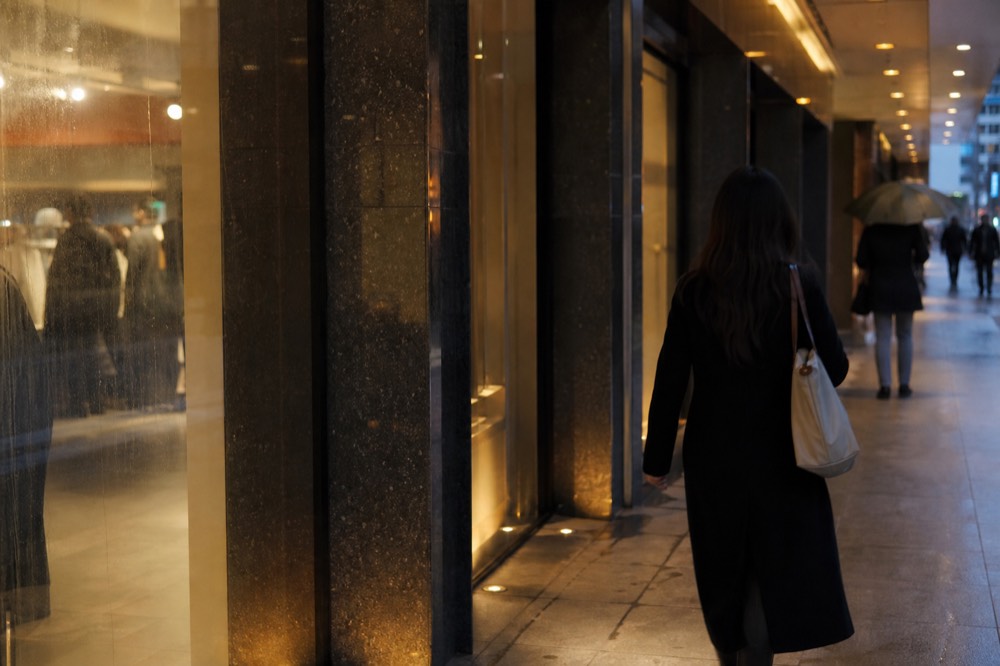 Mall corridor with soft lighting and storefronts at dusk, no text, no logos, no people